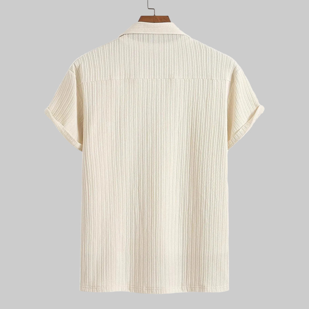 Beige short-sleeve shirt on a hanger with a white background