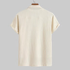 Beige short-sleeve shirt on a hanger with a white background
