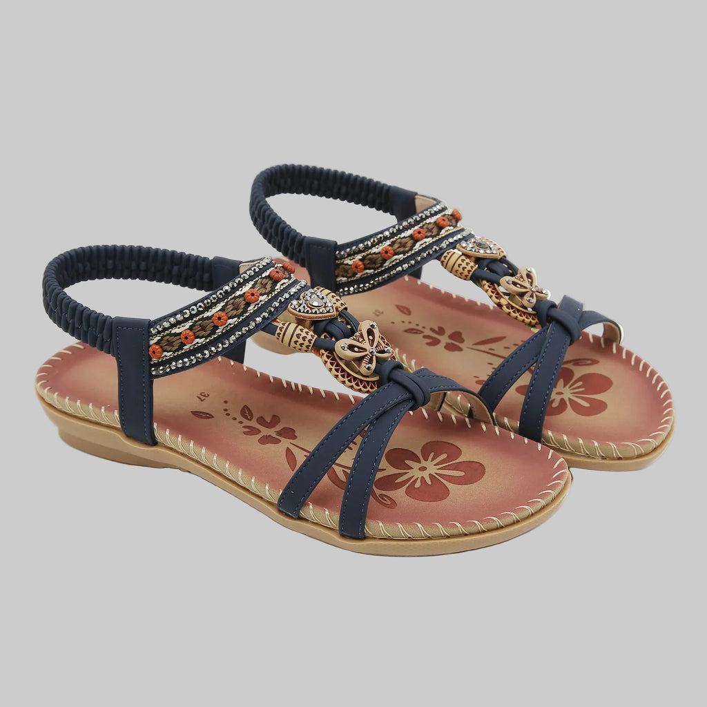 Pair of embellished sandals with floral designs on a white background