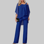 Woman wearing a blue outfit with a blurred indoor background