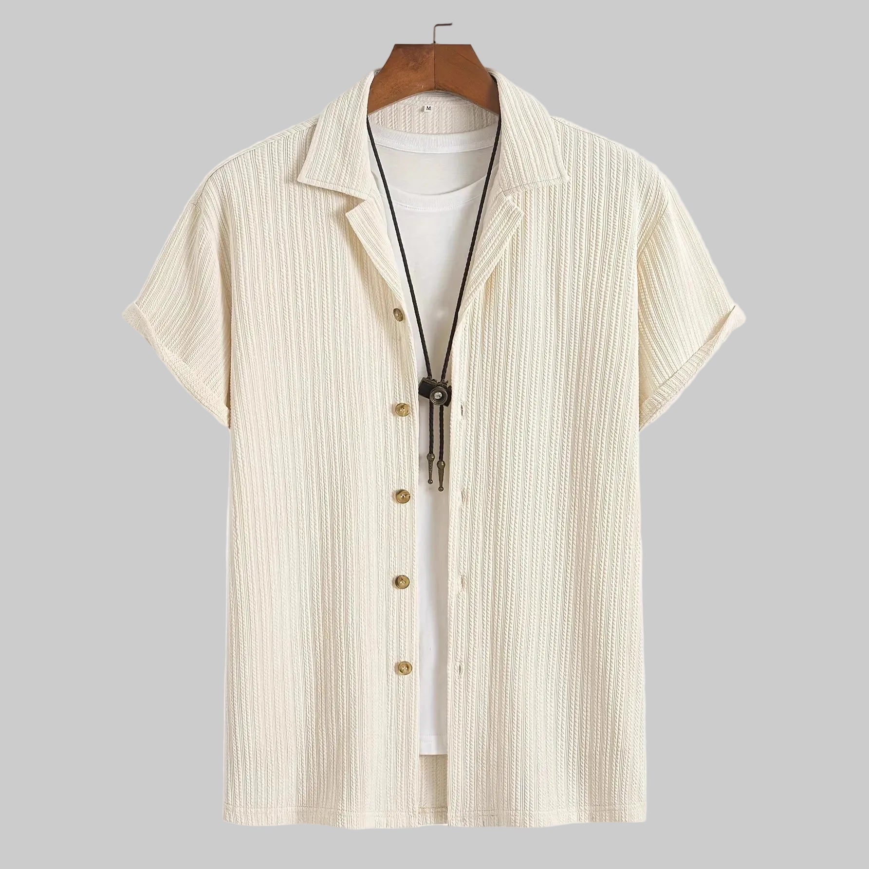 Beige short-sleeve shirt with zipper on a hanger against a white background