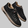 Black leather sneakers with tan soles 