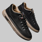Black leather sneakers with tan soles 