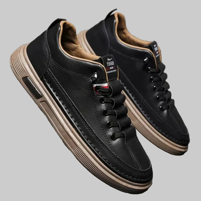 Black leather sneakers with tan soles 