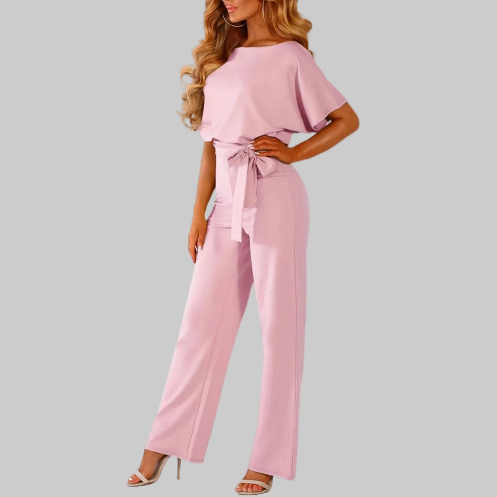 Pink jumpsuit worn by a model on a white background