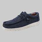 Navy blue casual shoe with white sole on a white background