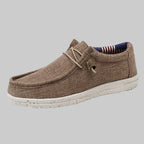 Brown casual shoe with a white sole on a white background