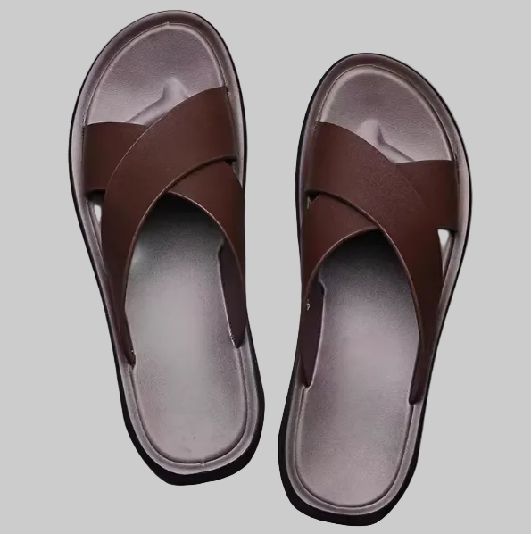 Pair of brown sandals on a gray background