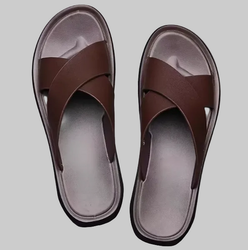 Pair of brown sandals on a gray background